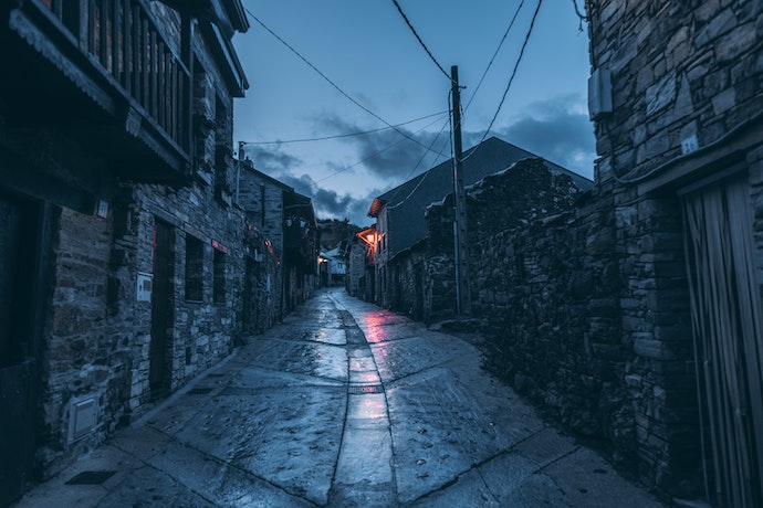 Empty, narrow street by night