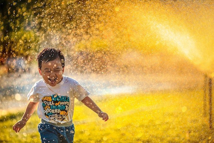 Kid running through water