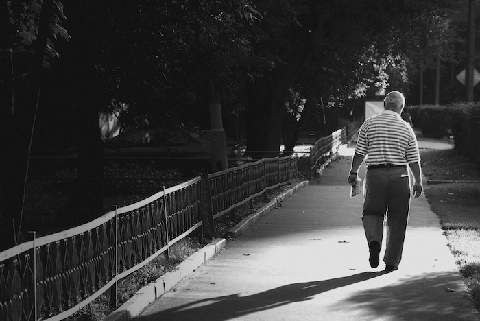 Older man walking on the sidewalk