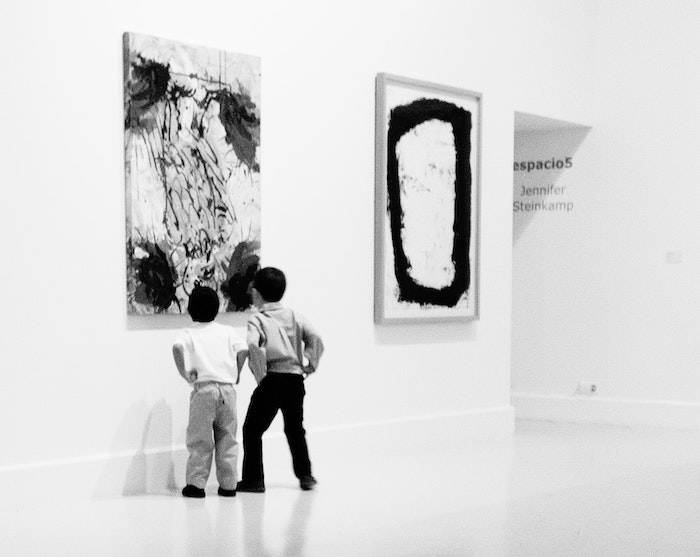 2 boys looking at art