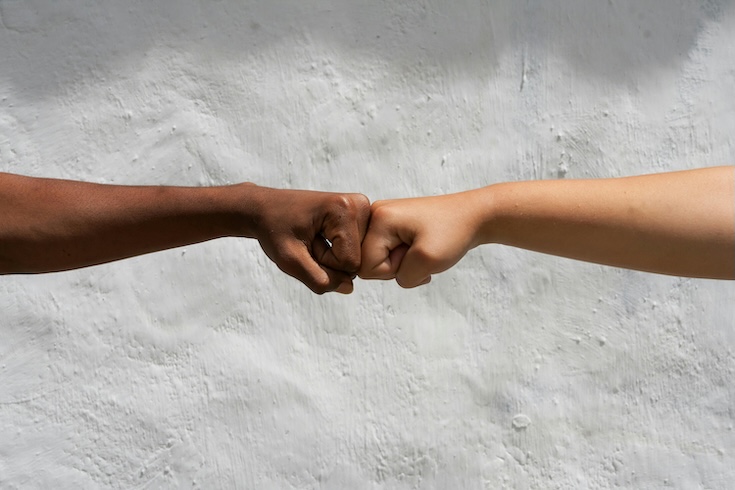 2 kids fist-bumping